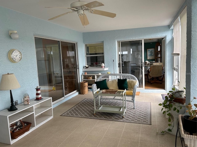 sunroom featuring ceiling fan