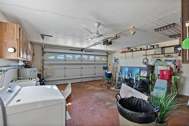 garage with washer / clothes dryer, a garage door opener, and water heater