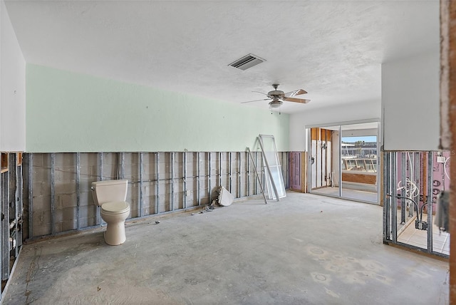 interior space with ceiling fan, concrete floors, and a textured ceiling