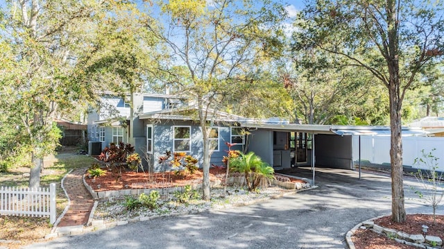 view of front of house with a carport and central air condition unit