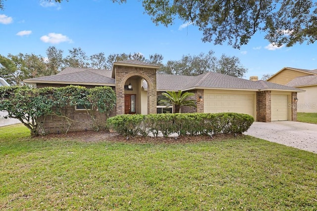 view of front of home featuring a garage and a front lawn