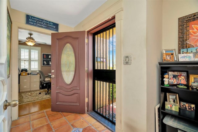 entryway with light tile patterned floors and ceiling fan