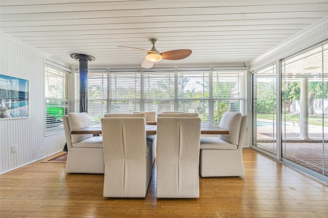 sunroom / solarium featuring ceiling fan