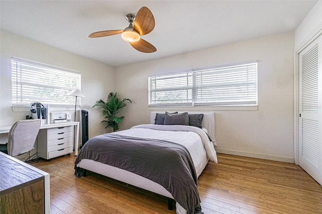bedroom featuring ceiling fan, light wood-type flooring, and a closet