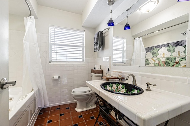 full bathroom with shower / bathtub combination with curtain, sink, tile walls, tile patterned floors, and toilet