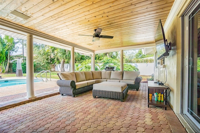 sunroom / solarium featuring ceiling fan, a healthy amount of sunlight, and wooden ceiling