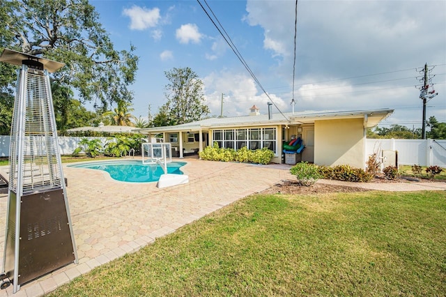 view of pool featuring a lawn and a patio