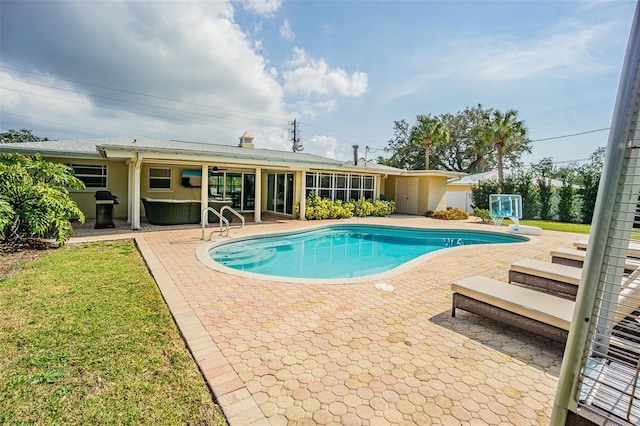 view of pool with grilling area and a patio