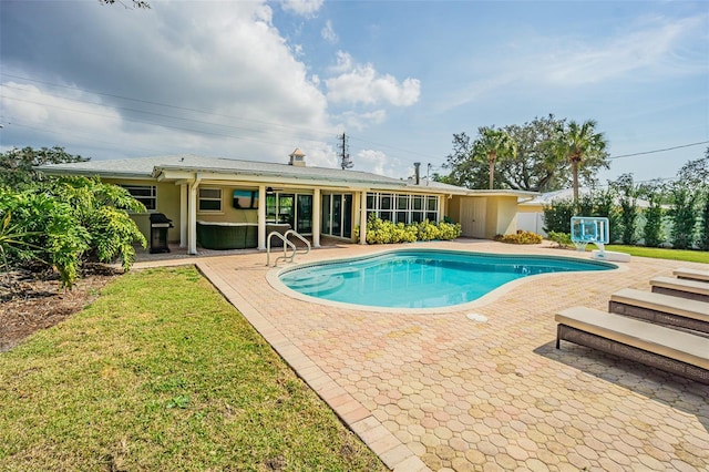 view of pool featuring a grill and a patio area