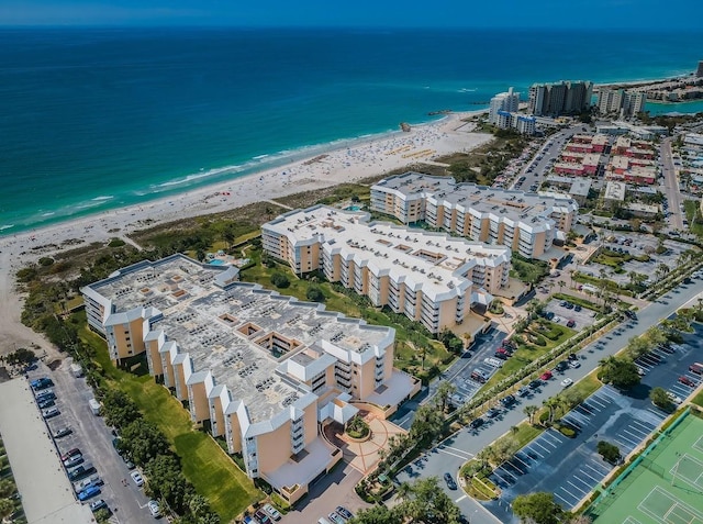 aerial view with a water view and a beach view