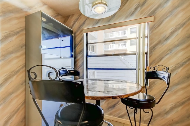 dining room with wooden walls