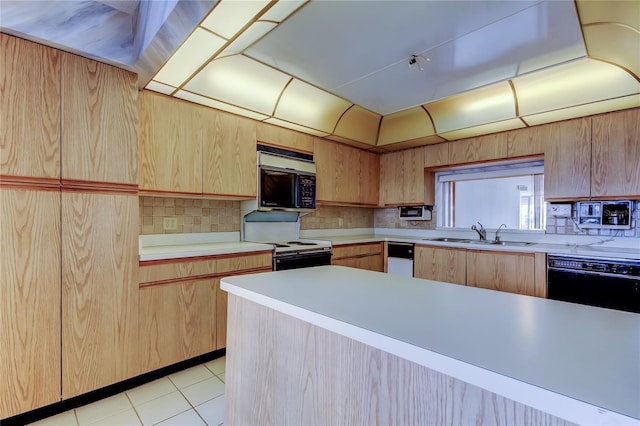 kitchen featuring tasteful backsplash, sink, light brown cabinetry, and black appliances