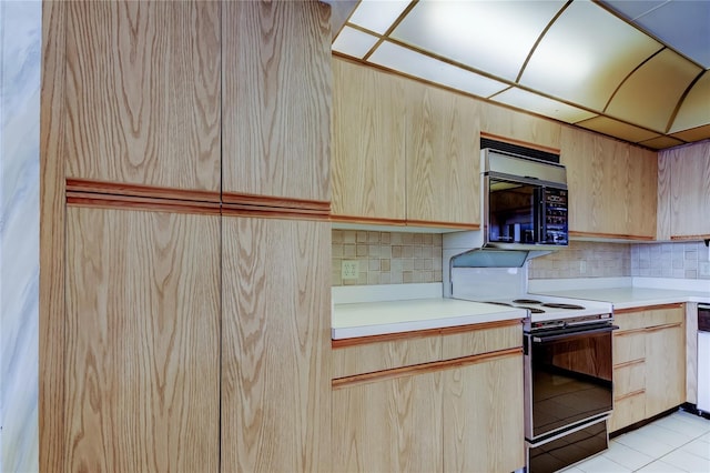 kitchen with light tile patterned floors, black / electric stove, stainless steel dishwasher, light brown cabinets, and backsplash