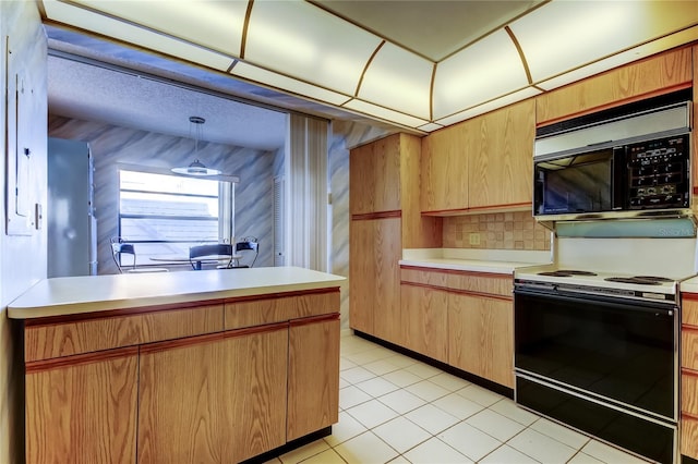 kitchen featuring decorative light fixtures, electric range oven, and light tile patterned floors