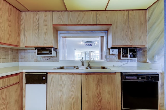 kitchen with dishwasher, sink, light brown cabinets, and decorative backsplash