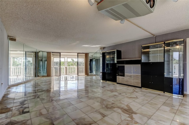 unfurnished living room featuring a textured ceiling