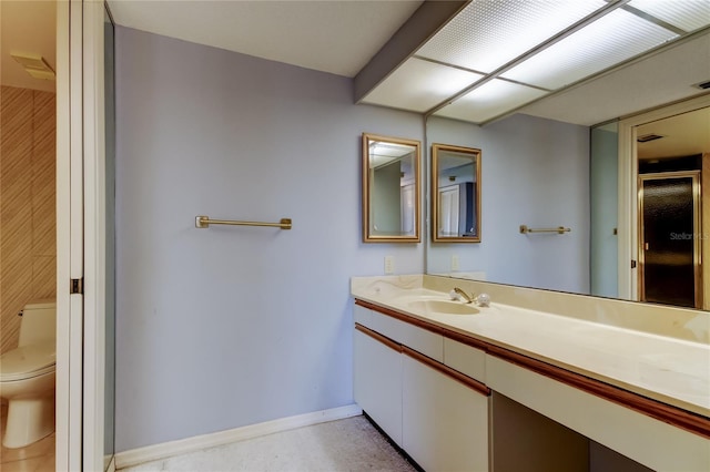 bathroom featuring vanity and toilet