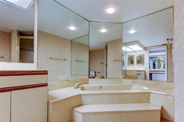 bathroom with vanity and separate shower and tub