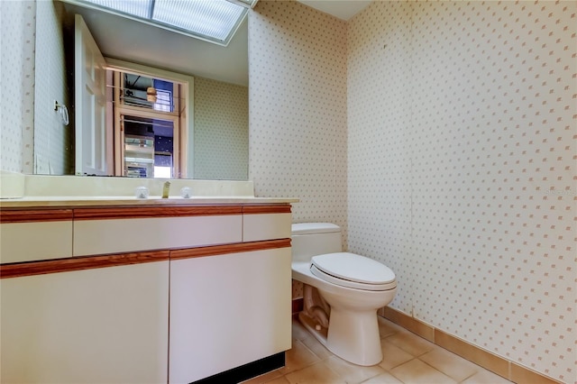 bathroom featuring vanity, tile patterned floors, and toilet