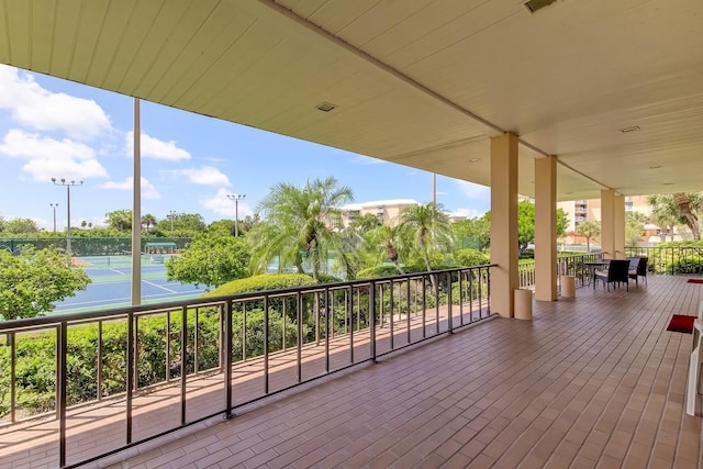 deck featuring tennis court