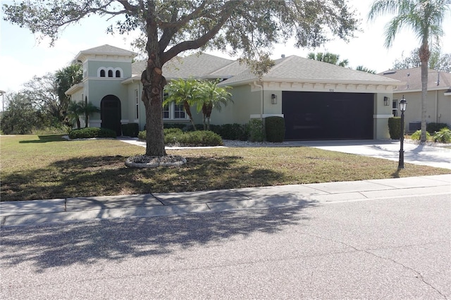 view of front of home featuring a garage and a front yard