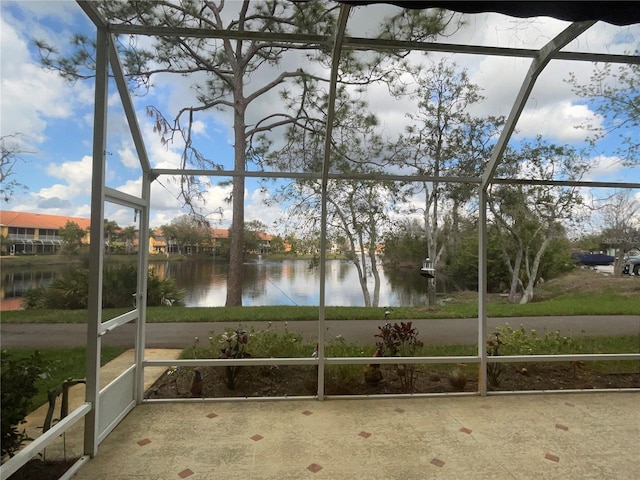 unfurnished sunroom featuring a water view