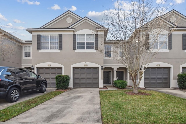 view of property featuring a garage and a front yard