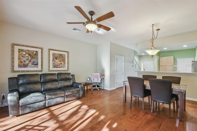 dining room with hardwood / wood-style flooring and ceiling fan