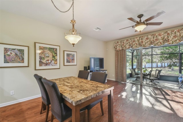 dining room featuring dark wood-type flooring and ceiling fan