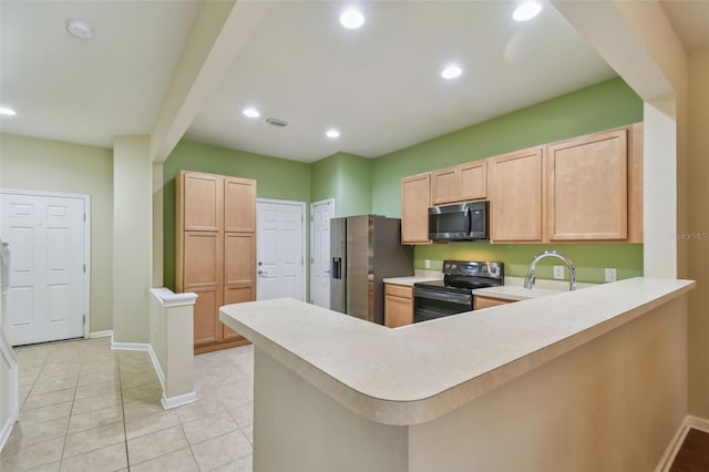 kitchen with light brown cabinetry, sink, light tile patterned floors, kitchen peninsula, and black appliances