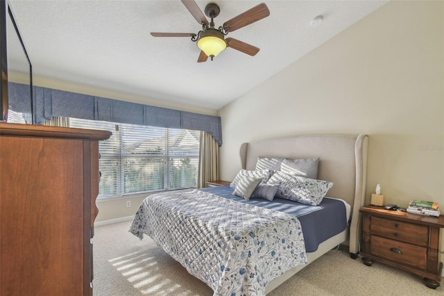 carpeted bedroom featuring vaulted ceiling and ceiling fan