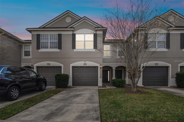 view of front facade with a garage and a lawn