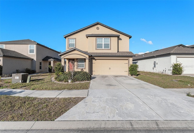 view of property featuring a garage and a front yard