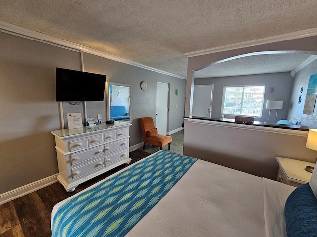 bedroom featuring ornamental molding, hardwood / wood-style floors, and a textured ceiling