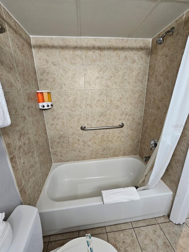 bathroom featuring shower / bath combination with curtain, tile patterned floors, and toilet