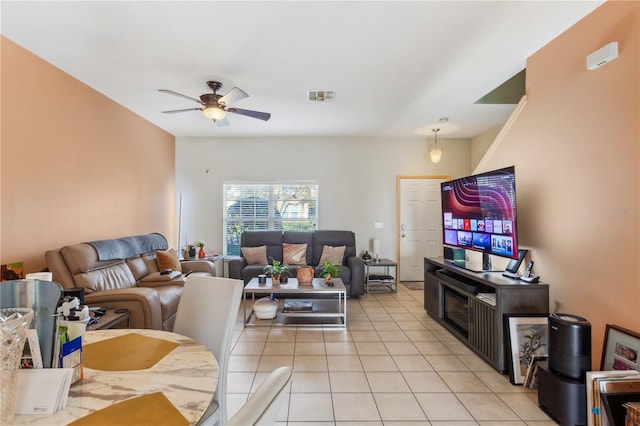 living area with light tile patterned floors, ceiling fan, and visible vents