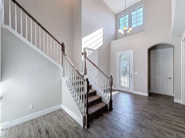 entrance foyer featuring a healthy amount of sunlight, stairs, baseboards, and wood tiled floor