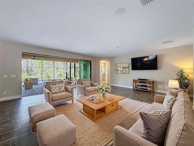 living area with visible vents, baseboards, and wood finished floors