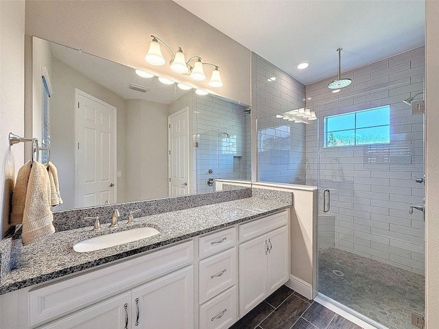 bathroom with an enclosed shower and vanity