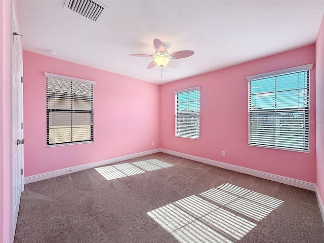 spare room featuring ceiling fan, carpet flooring, and a textured ceiling