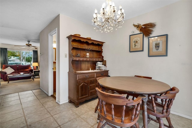 dining room featuring ceiling fan with notable chandelier and light tile patterned floors