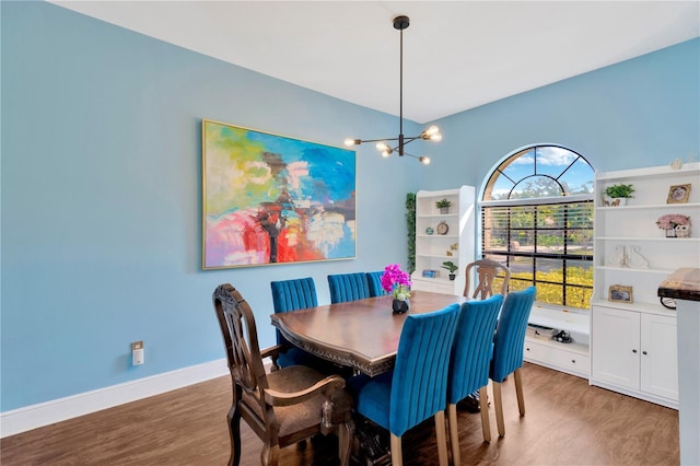 dining space featuring hardwood / wood-style floors and a notable chandelier