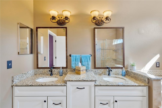 bathroom with vanity and a shower with door