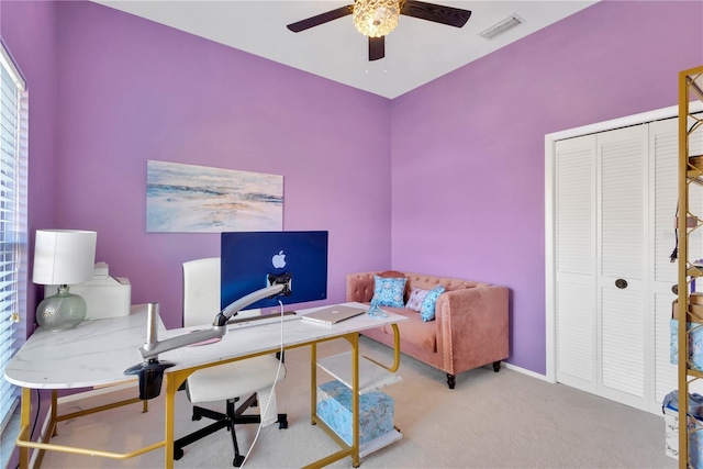 carpeted home office with ceiling fan