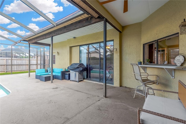 view of patio featuring a grill, a lanai, an outdoor hangout area, an outdoor bar, and a mountain view