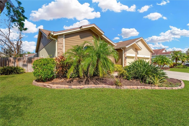 view of property exterior with a garage and a yard