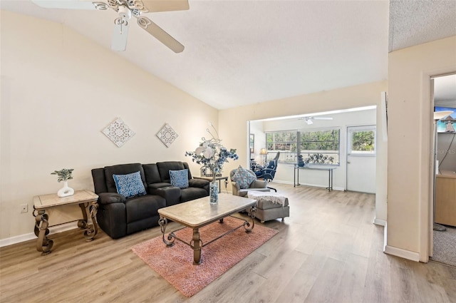 living room with ceiling fan, a textured ceiling, and light wood-type flooring