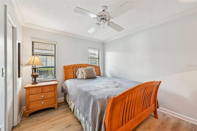 bedroom featuring ornamental molding, ceiling fan, a textured ceiling, and light hardwood / wood-style floors