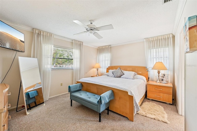 bedroom with crown molding, light colored carpet, and a textured ceiling