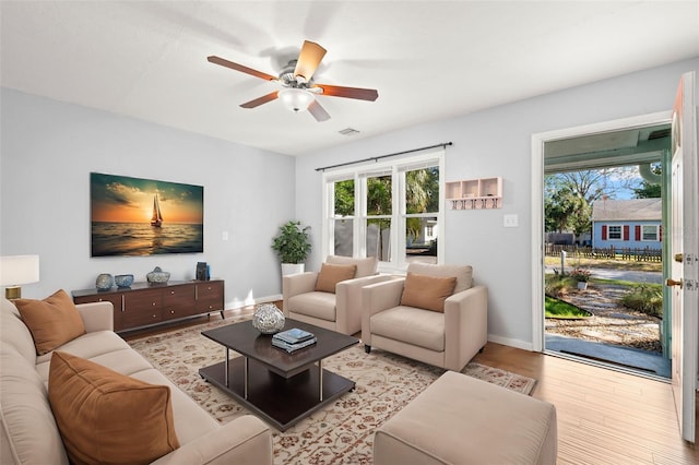 living room featuring ceiling fan and light hardwood / wood-style floors